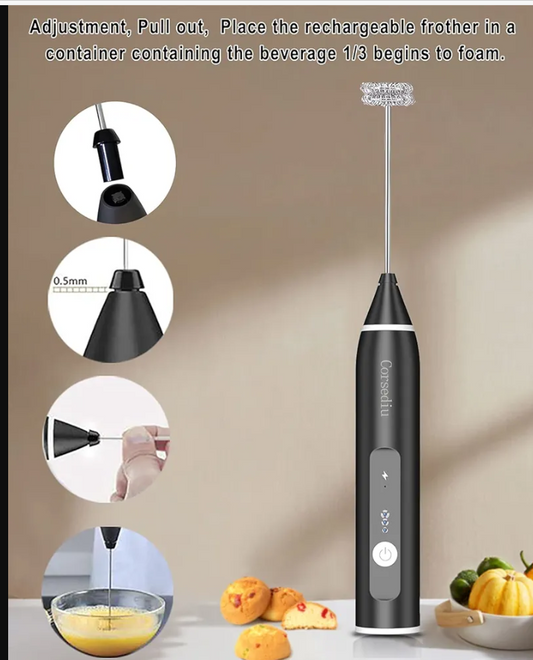 Black handheld milk frother with usage instructions on a beige background