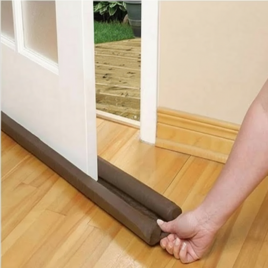 Door draft excluder on a wooden floor.