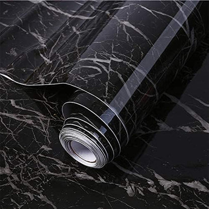 Roll of black marble patterned contact paper on a black marble background