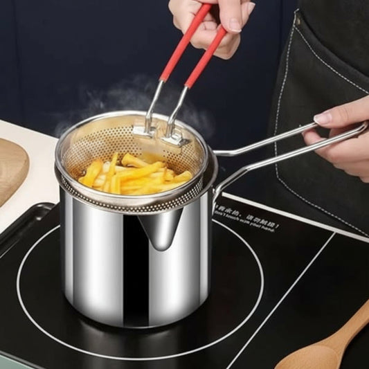 Stainless steel pot with a mesh strainer on a stovetop, being used to cook food.
